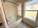 Clean bathroom with shower/tub combo and large window at 8417 Secret Key Cove, Kissimmee, FL 34747