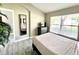 Main bedroom with a queen bed, dresser and large window at 8417 Secret Key Cove, Kissimmee, FL 34747
