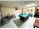 Fun game room with pool table, seating, and garage access at 8417 Secret Key Cove, Kissimmee, FL 34747