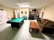 Game room features a pool table, seating, and storage at 8417 Secret Key Cove, Kissimmee, FL 34747