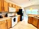 Bright kitchen with oak cabinets, new flooring, and modern appliances at 8417 Secret Key Cove, Kissimmee, FL 34747