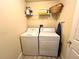 Laundry room with washer, dryer, and storage shelf at 8417 Secret Key Cove, Kissimmee, FL 34747