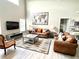 Spacious living room featuring comfortable sofas, a large TV, and a stylish coffee table at 8417 Secret Key Cove, Kissimmee, FL 34747