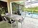 Outdoor patio furniture with a view of the pool and lake at 8417 Secret Key Cove, Kissimmee, FL 34747