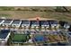 Aerial view of a residential community showcasing modern townhomes, a playground, and recreational facilities near a golf course at 853 Ocean Course Ave # 853, Davenport, FL 33896