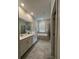 Well-lit bathroom with a double vanity, a soaking tub, and a glass-enclosed shower at 853 Ocean Course Ave # 853, Davenport, FL 33896