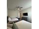 Cozy bedroom featuring two beds, neutral walls, ceiling fan, and a wall-mounted television at 853 Ocean Course Ave # 853, Davenport, FL 33896
