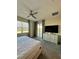 Bedroom with a large bed, dresser, and sliding glass doors to a private balcony at 853 Ocean Course Ave # 853, Davenport, FL 33896