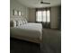 Serene bedroom with a king bed, neutral walls, and large windows with curtains at 853 Ocean Course Ave # 853, Davenport, FL 33896