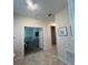 Hallway leading to a bedroom with TV, dresser, and striped decor at 853 Ocean Course Ave # 853, Davenport, FL 33896