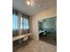 Hallway leading to a bedroom with TV, dresser, and striped decor at 853 Ocean Course Ave # 853, Davenport, FL 33896