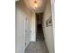 Welcoming hallway with tiled flooring, neutral walls, staircase, and decorative artwork at 853 Ocean Course Ave # 853, Davenport, FL 33896