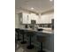 Modern kitchen with white cabinets, quartz countertops, pendant lighting, stainless appliances, and breakfast bar with seating at 853 Ocean Course Ave # 853, Davenport, FL 33896