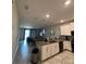 Bright kitchen with an island, stainless steel appliances and pendant lighting at 853 Ocean Course Ave # 853, Davenport, FL 33896