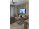 Relaxing living room with a ceiling fan, gray sofa, decorative wall, and a large screen TV with ocean view at 853 Ocean Course Ave # 853, Davenport, FL 33896