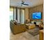 Relaxing living room with a ceiling fan, gray sofa, decorative wall, and a large screen TV with ocean view at 853 Ocean Course Ave # 853, Davenport, FL 33896