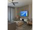 Relaxing living room with a ceiling fan, gray sofa, decorative wall, and a large screen TV with ocean view at 853 Ocean Course Ave # 853, Davenport, FL 33896