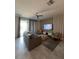 Stylish living room with modern furniture, a ceiling fan, and a sliding glass door at 853 Ocean Course Ave # 853, Davenport, FL 33896