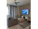 Relaxing living room with a ceiling fan, gray sofa, decorative wall, and a large screen TV with ocean view at 853 Ocean Course Ave # 853, Davenport, FL 33896