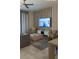 Relaxing living room with a ceiling fan, gray sofa, decorative wall, and a large screen TV with ocean view at 853 Ocean Course Ave # 853, Davenport, FL 33896