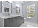 Elegant bathroom with double vanity, quartz countertop, and large window at 854 Spring Park Loop, Celebration, FL 34747