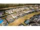 Aerial view of houses with pools in a neighborhood by a lake at 8614 La Isla Dr, Kissimmee, FL 34747