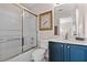 Modern bathroom with dark blue vanity, glass shower, and toilet at 8614 La Isla Dr, Kissimmee, FL 34747