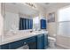 Clean bathroom, featuring dark blue vanity, shower/tub combo at 8614 La Isla Dr, Kissimmee, FL 34747