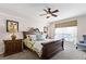 Primary bedroom with a large bed and ensuite bathroom at 8614 La Isla Dr, Kissimmee, FL 34747