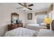 Bright bedroom featuring twin beds, ceiling fan, and built-in dresser at 8614 La Isla Dr, Kissimmee, FL 34747