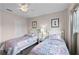 Spacious bedroom with twin beds, ceiling fan and closet at 8614 La Isla Dr, Kissimmee, FL 34747