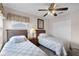 Well-lit bedroom with twin beds, ceiling fan, and closet at 8614 La Isla Dr, Kissimmee, FL 34747