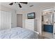 Bedroom with a double bed, dresser, and ensuite bathroom at 8614 La Isla Dr, Kissimmee, FL 34747