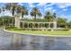 Ornate entrance to Emerald Island with palm trees and fountain at 8614 La Isla Dr, Kissimmee, FL 34747