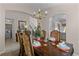 Dining room with a large table, chandelier, and view of the laundry room at 8614 La Isla Dr, Kissimmee, FL 34747