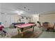 Spacious game room with pool table, air hockey, and seating area at 8614 La Isla Dr, Kissimmee, FL 34747