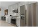 Kitchen with gray cabinets, stainless steel appliances, and quartz countertops at 8614 La Isla Dr, Kissimmee, FL 34747