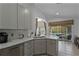Kitchen with gray cabinets, stainless steel appliances, and a view of the pool at 8614 La Isla Dr, Kissimmee, FL 34747