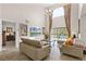 Bright living room with vaulted ceilings, two sofas, and views of the pool at 8614 La Isla Dr, Kissimmee, FL 34747
