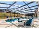 Inviting pool area with screened enclosure, lounge chairs, and table at 8614 La Isla Dr, Kissimmee, FL 34747