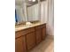 Double vanity bathroom with granite countertops and wood cabinets at 8968 California Palm Rd, Kissimmee, FL 34747