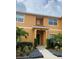 Inviting exterior of a two-story townhome with landscaping at 8968 California Palm Rd, Kissimmee, FL 34747