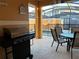 Outdoor patio with grill, seating area, and pool view at 8968 California Palm Rd, Kissimmee, FL 34747