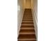 Wooden staircase leading to the upper level of the home at 8968 California Palm Rd, Kissimmee, FL 34747