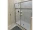 Modern bathroom with a glass-enclosed shower featuring marble tiling and a neutral color scheme at 9158 Scramble Dr, Davenport, FL 33896