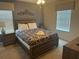 Comfortable bedroom features a wood-frame bed with a patterned cover, plus two matching nightstands at 9158 Scramble Dr, Davenport, FL 33896