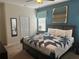 Comfortable bedroom with a queen-size bed, soft carpet, and a modern color scheme at 9158 Scramble Dr, Davenport, FL 33896
