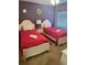 Bright bedroom with twin beds, side table, overhead lighting, and neutral carpeting at 9158 Scramble Dr, Davenport, FL 33896