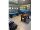 Garage game room complete with pool tables, foosball, and fun wall art, offering endless entertainment options for all at 9158 Scramble Dr, Davenport, FL 33896