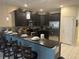 Modern kitchen boasting sleek dark cabinetry, stainless steel appliances, granite counters, and stylish backsplash for culinary enthusiasts at 9158 Scramble Dr, Davenport, FL 33896
